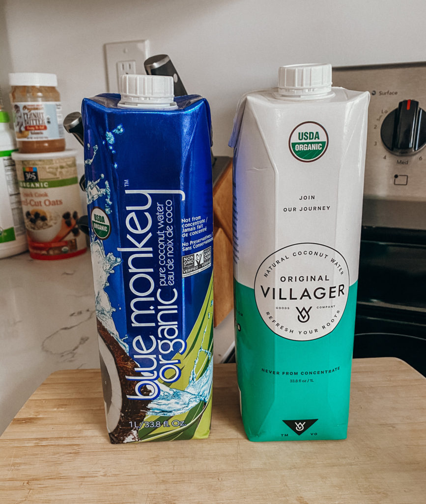 two one liter coconut waters blue monkey organic and original villager from erewhon sitting on a kitchen countertop